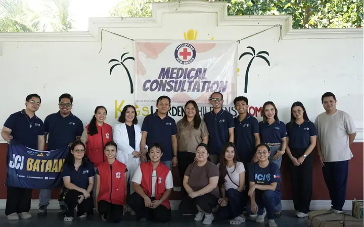 JCI Bataan members and Philippine Red Cross – Bataan Chapter volunteers posing together under a Medical Consultation banner.